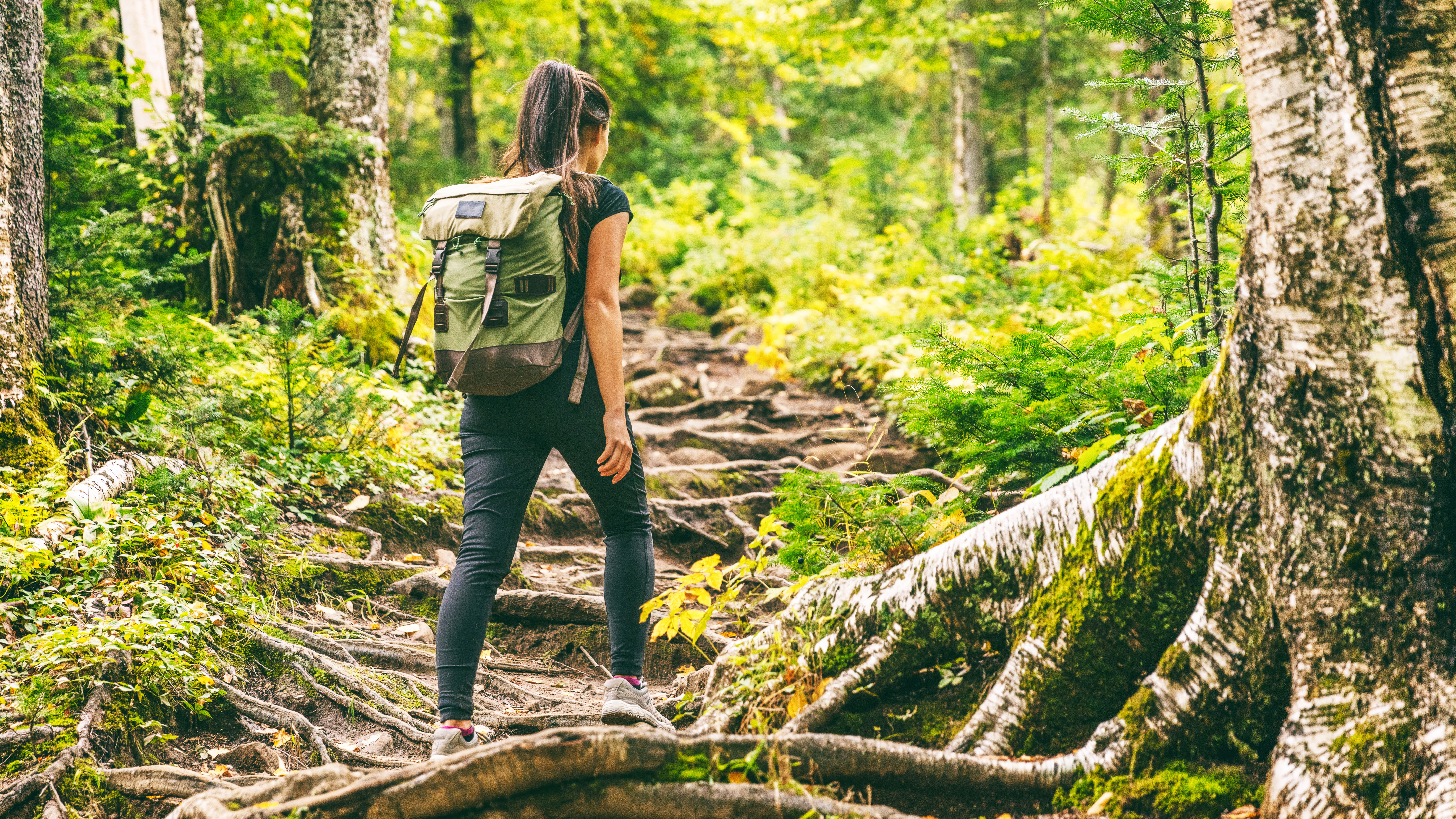 a photo of a woman walking uphill