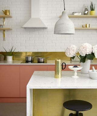 Coral and gold kitchen with ceramic pendant light