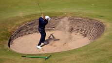 Jon Rahm plays out of a revetted bunker at Royal Birkdale during a practice round in 2026