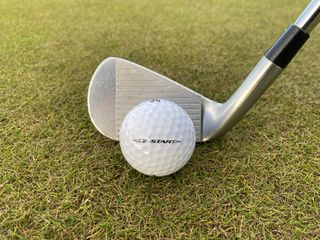 Photo of the srixon z star golf ball in front of an iron