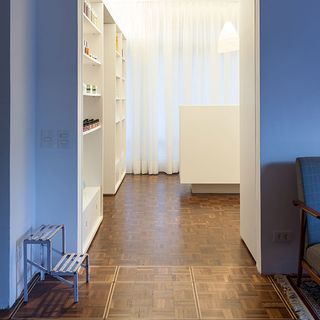 Room with chair and white shelves