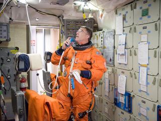 Mission Specialist Steve Bowen was picked to replace the injured Tim Kopra on the STS-133 flight. Here, he uses a communication system during a training session in the fixed-base shuttle mission simulator inside the Jake Garn Simulation and Training Facility at NASA's Johnson Space Center.