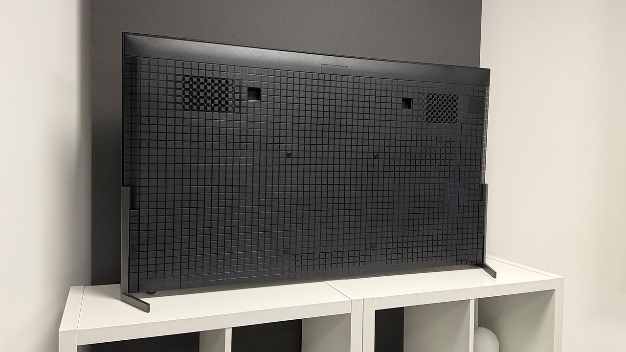 The 55-inch Sony Bravia 8 II QD-OLED TV photographed on a white table. On the screen is a nature documentary.