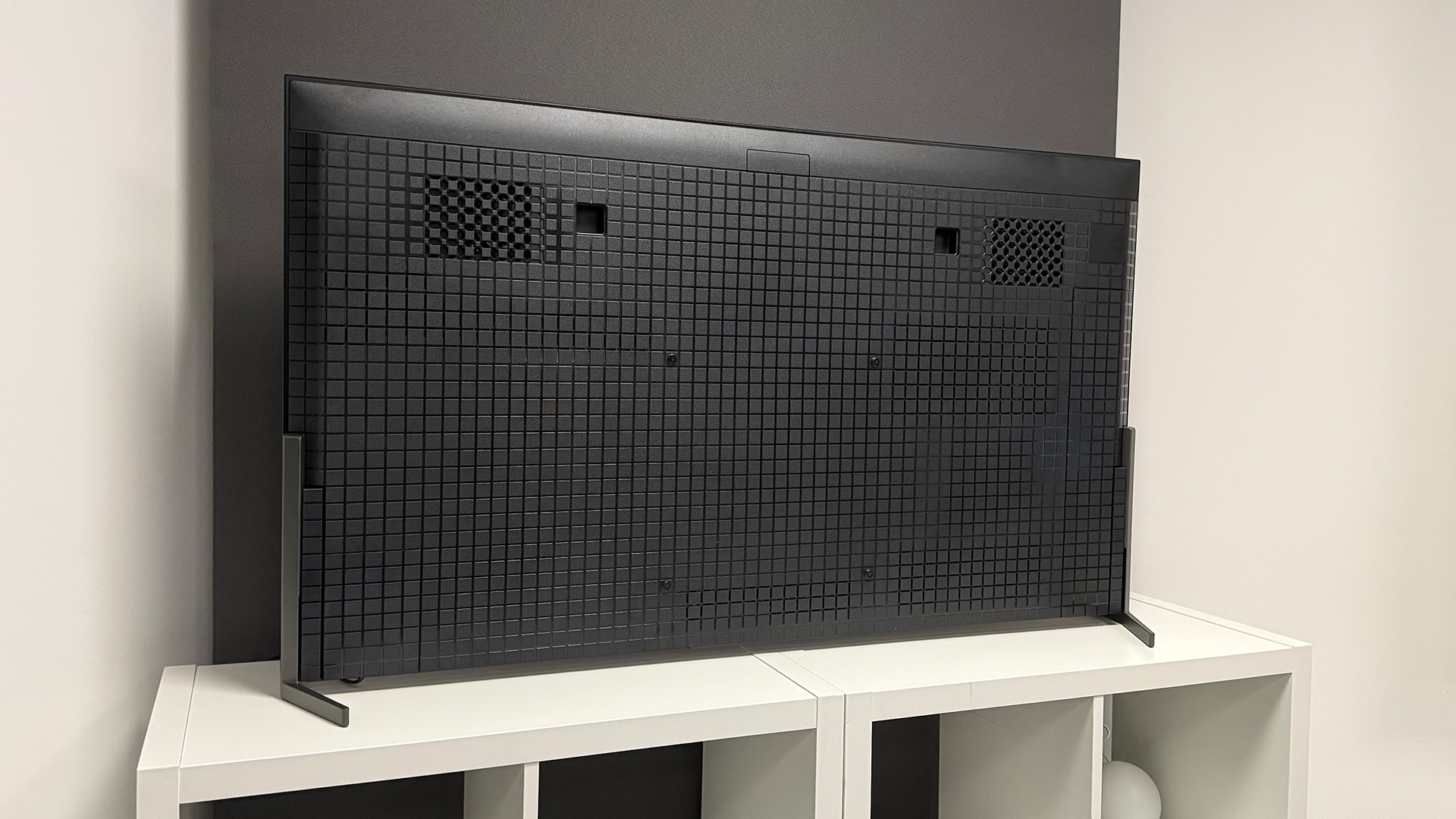 The 55-inch Sony Bravia 8 II QD-OLED TV photographed on a white table. On the screen is a nature documentary.