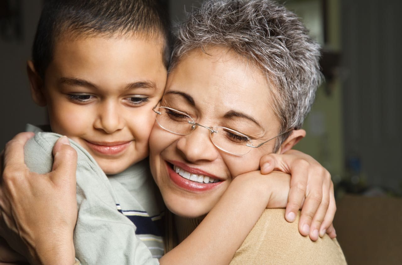 Grandmother and grandson embracing