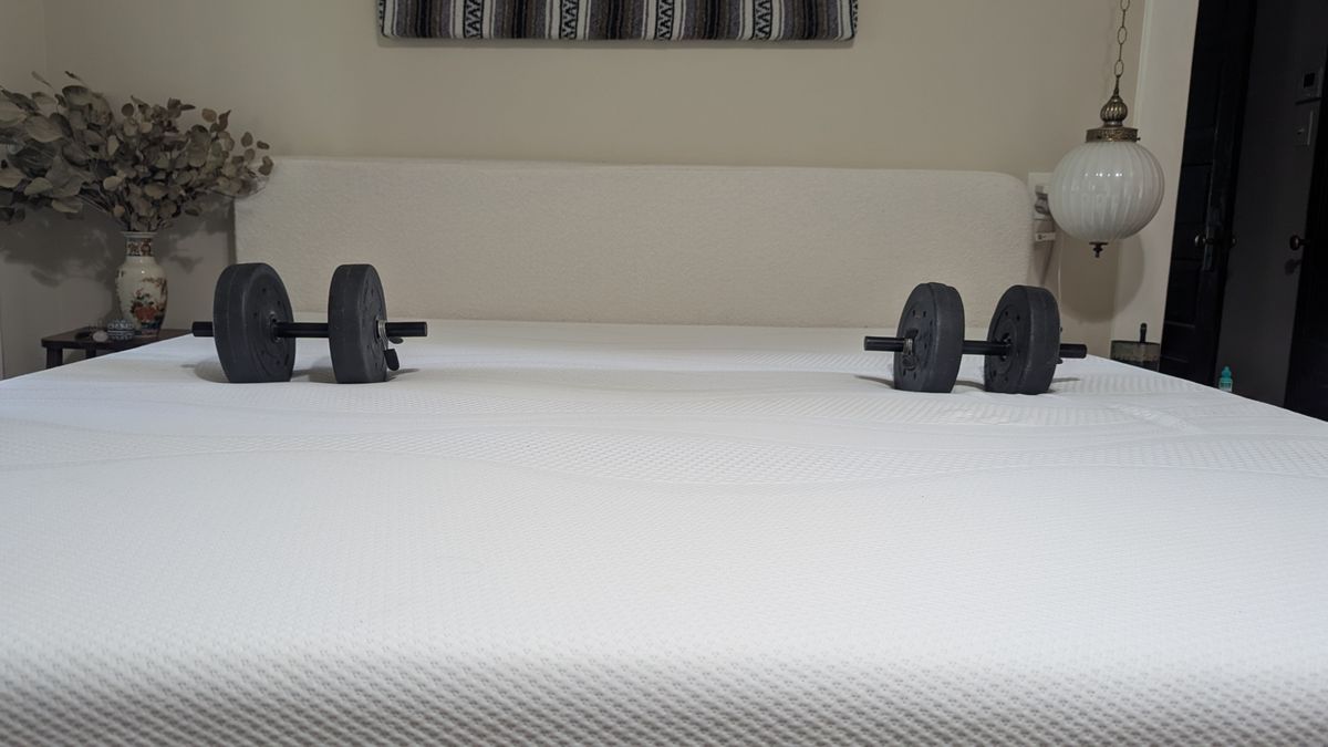 Dumbbells and wine glass placed on Sleep Number i8 smart mattress showing motion isolation