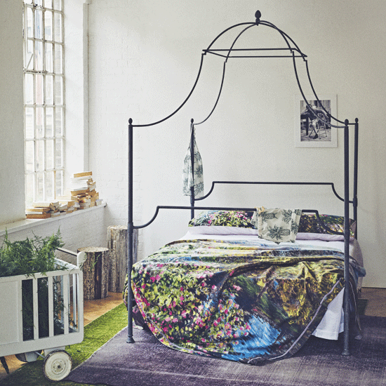 bedroom with white wall and cushions on bed