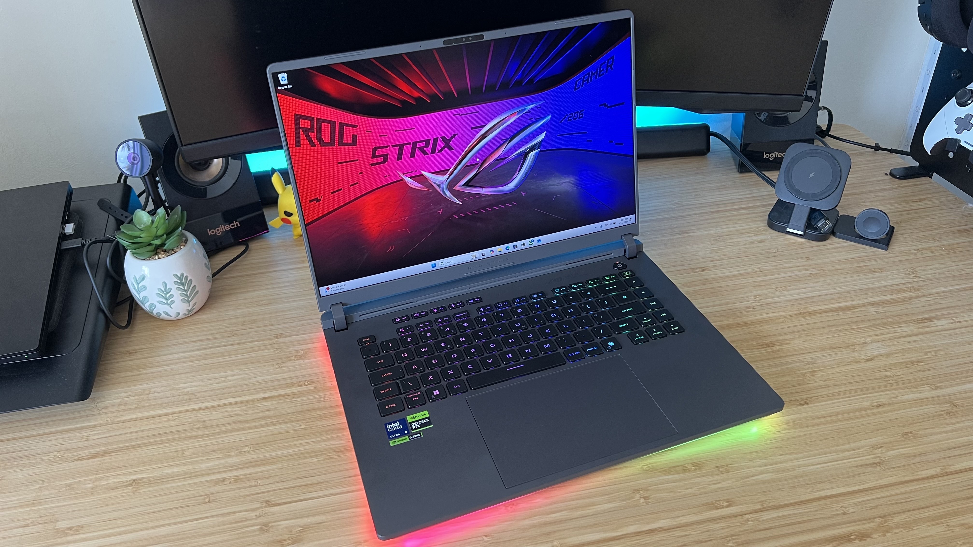 Asus ROG Strix G16 gaming laptop on a wooden desk