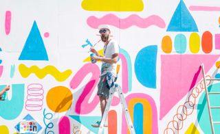 Mike Perry working on his mural in Brooklyn