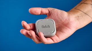 The Brick gadget photographed in front of a blue background