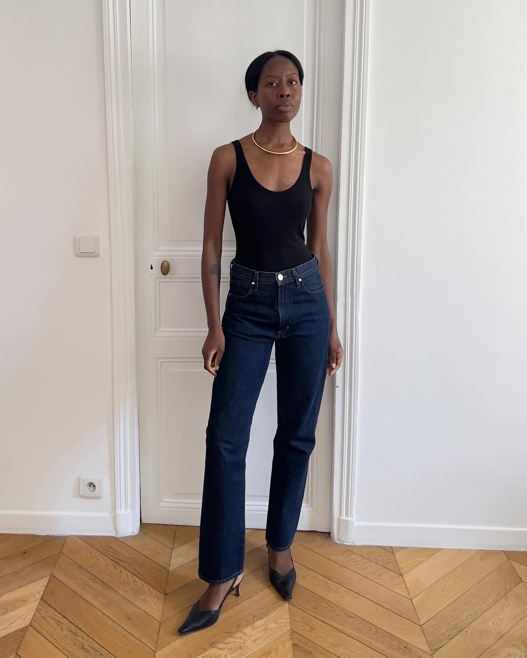 Sylvie Mus wearing a pair of dark-rinse jeans