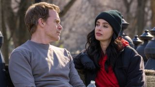 Dexter and Mia sitting on park bench outdoors in Dexter: Resurrection Episode 4