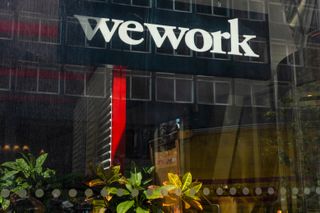 WeWork logo at an office entrance near Waterloo railway station in London, UK