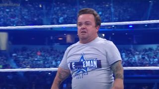 Wee Man at WrestleMania inside the ring, getting ready to body slam Sami Zayn.