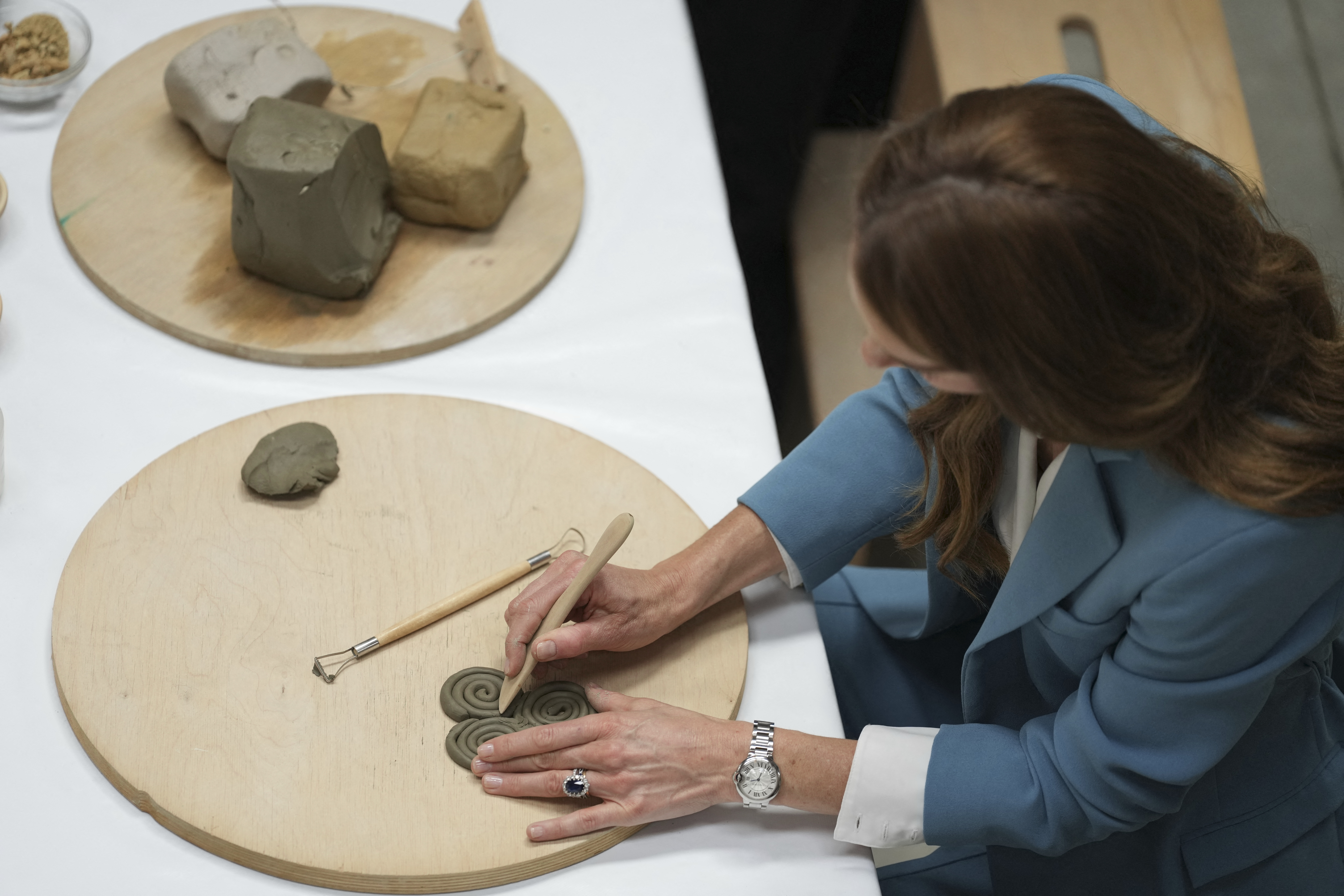 Princess Kate modeling clay on a table