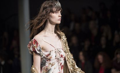 Model wearing floral outfit and a crown