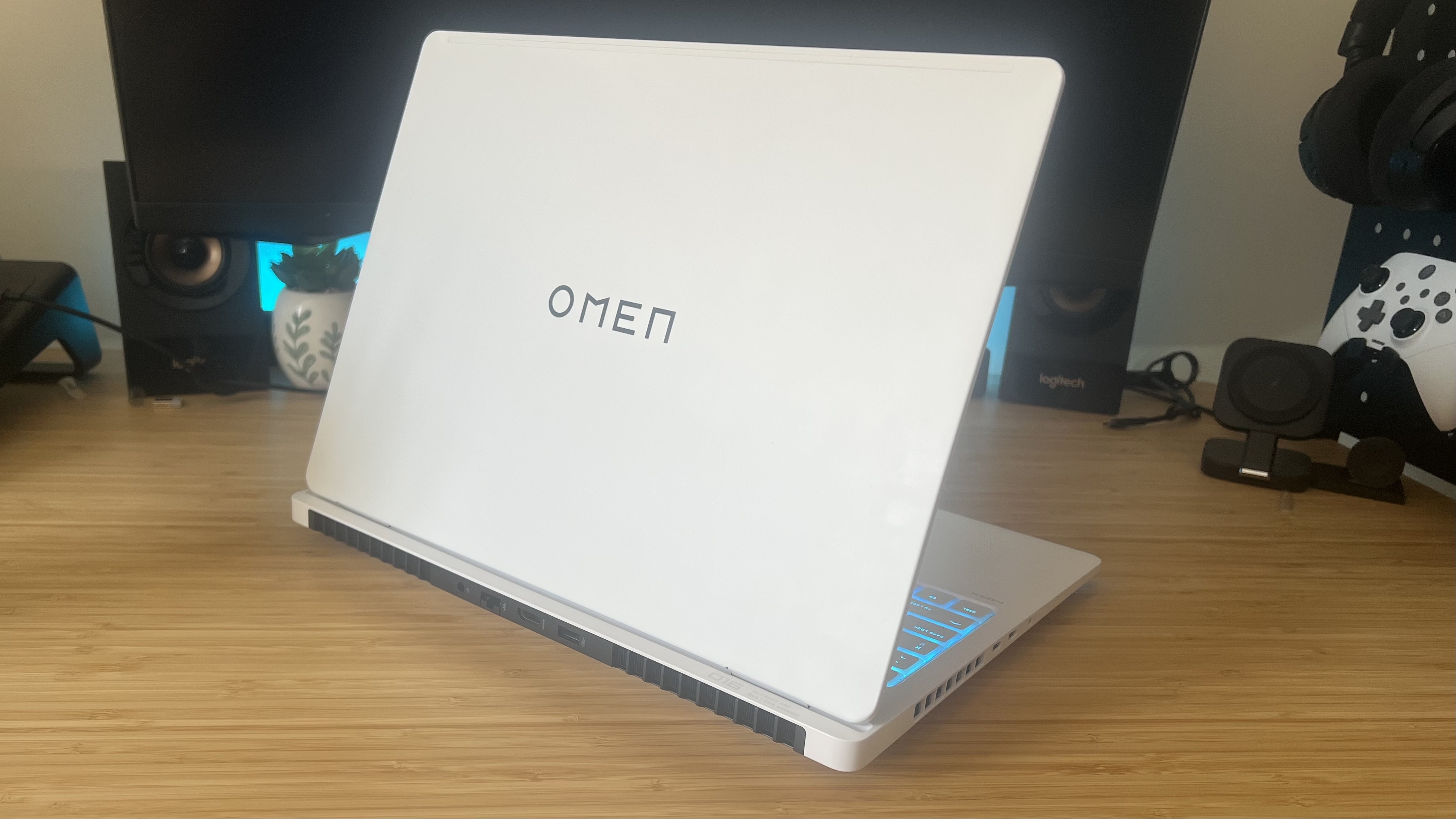 HP Omen Max 16 gaming laptop with lid open on a wooden desk
