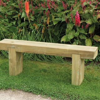 Wooden garden bench on lawn