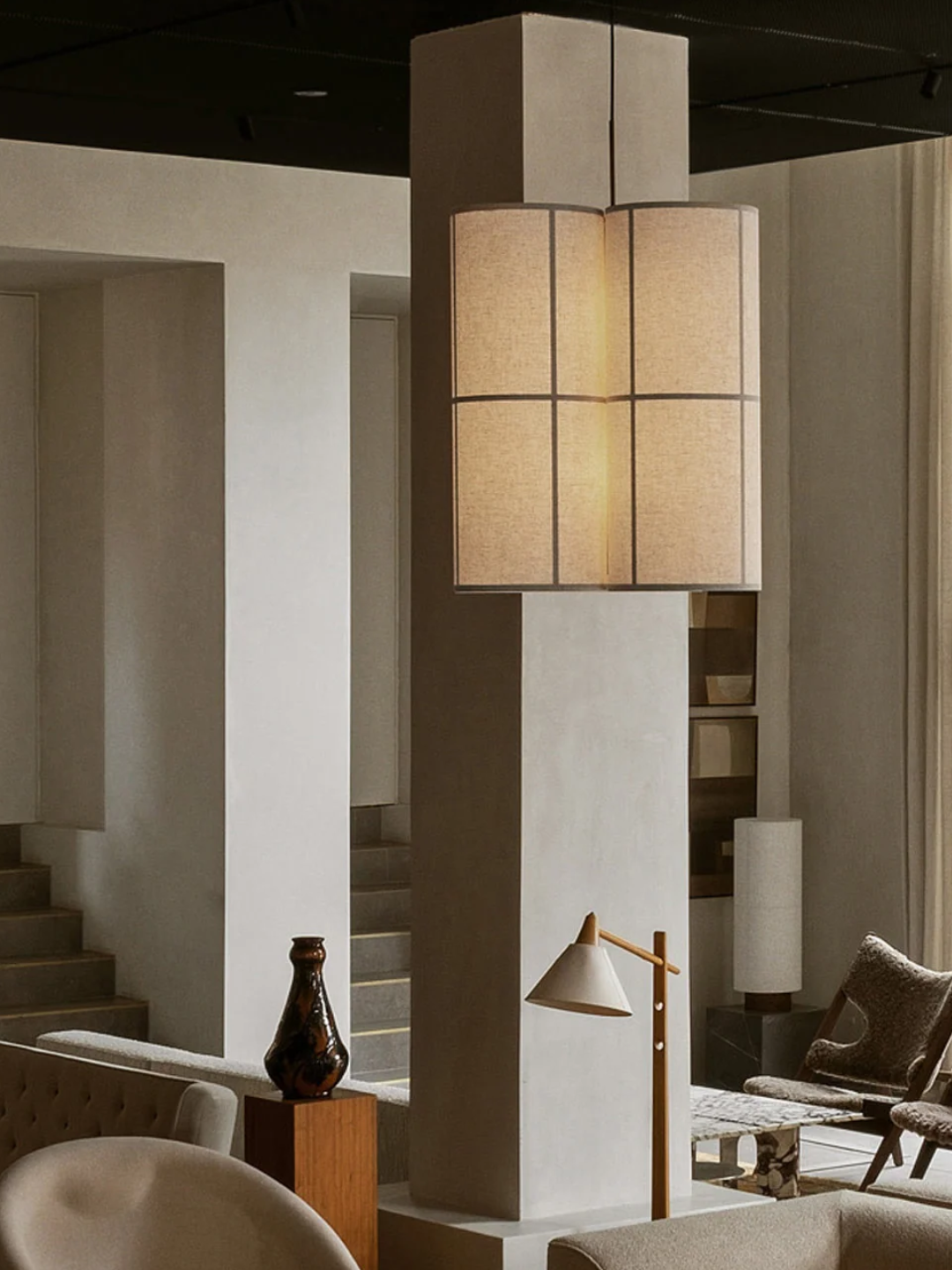 A handmade linen pendant lamp from Audo Copenhagen in a minimalist living room