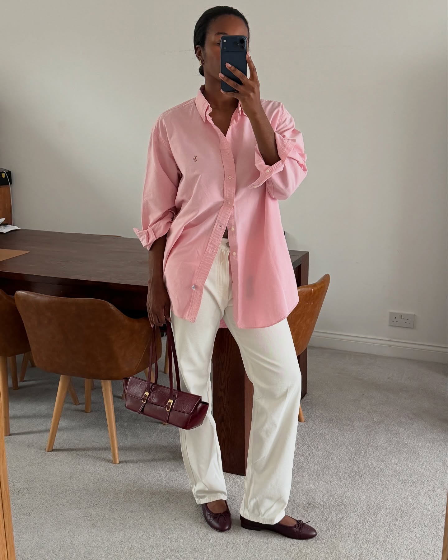 Marilyn NK in a pink Ralph Lauren button down and white jeans.