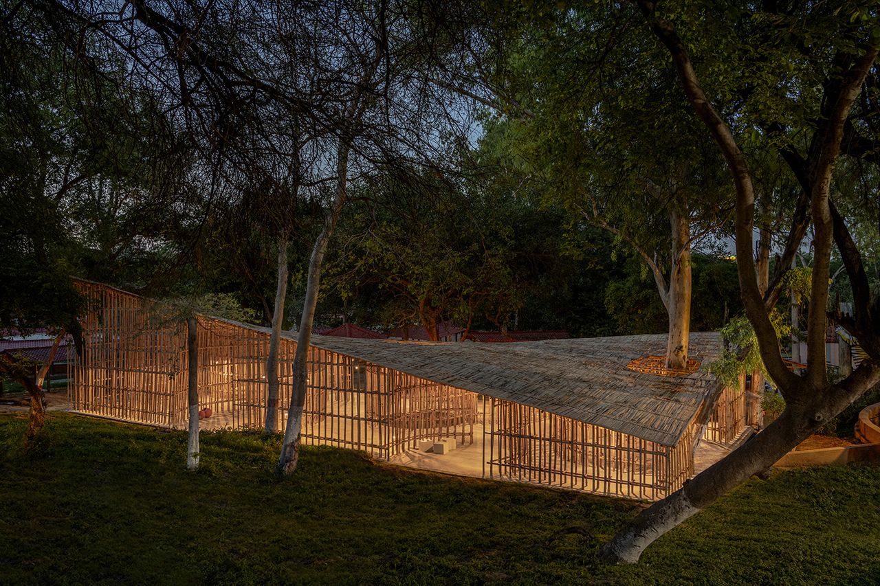 night time aerial shot of the Northeast Pavilion which is made of bamboo, among the trees