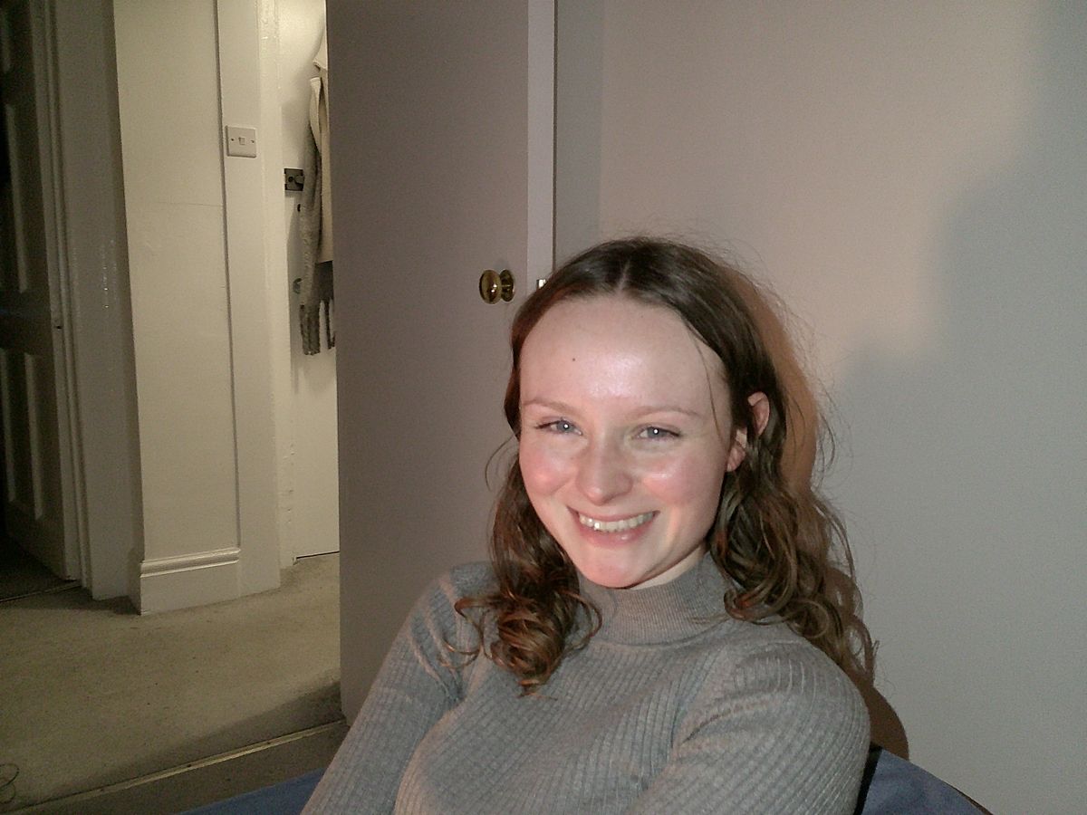 A photo of a woman smiling, taken on a Camp Snap Screen-Free digital camera