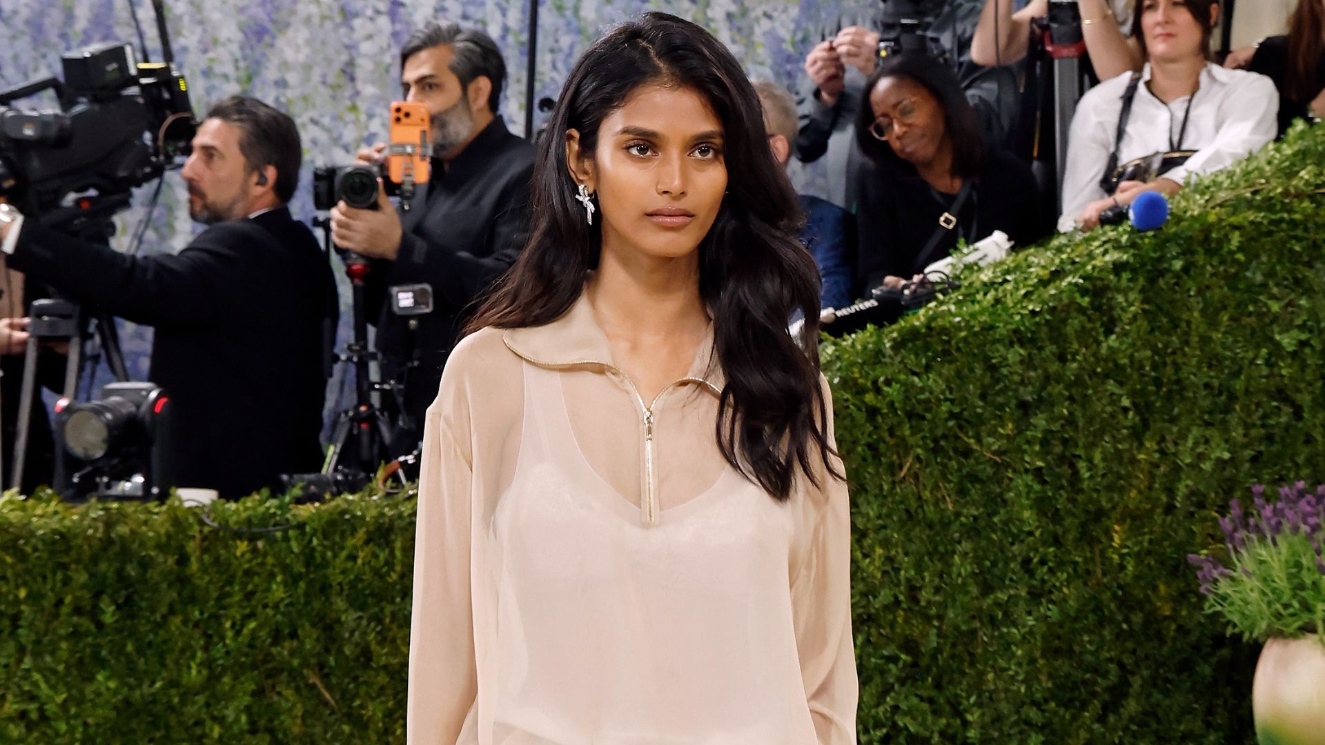Model Bhavitha Mandava wears straight-leg jeans and a sheer polo top and Chanel two-tone heels on the Met Gala 2026 red carpet.
