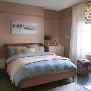 bedroom with terracotta walls, printed blind and sheer curtains