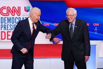 Biden and Sanders bump elbows
