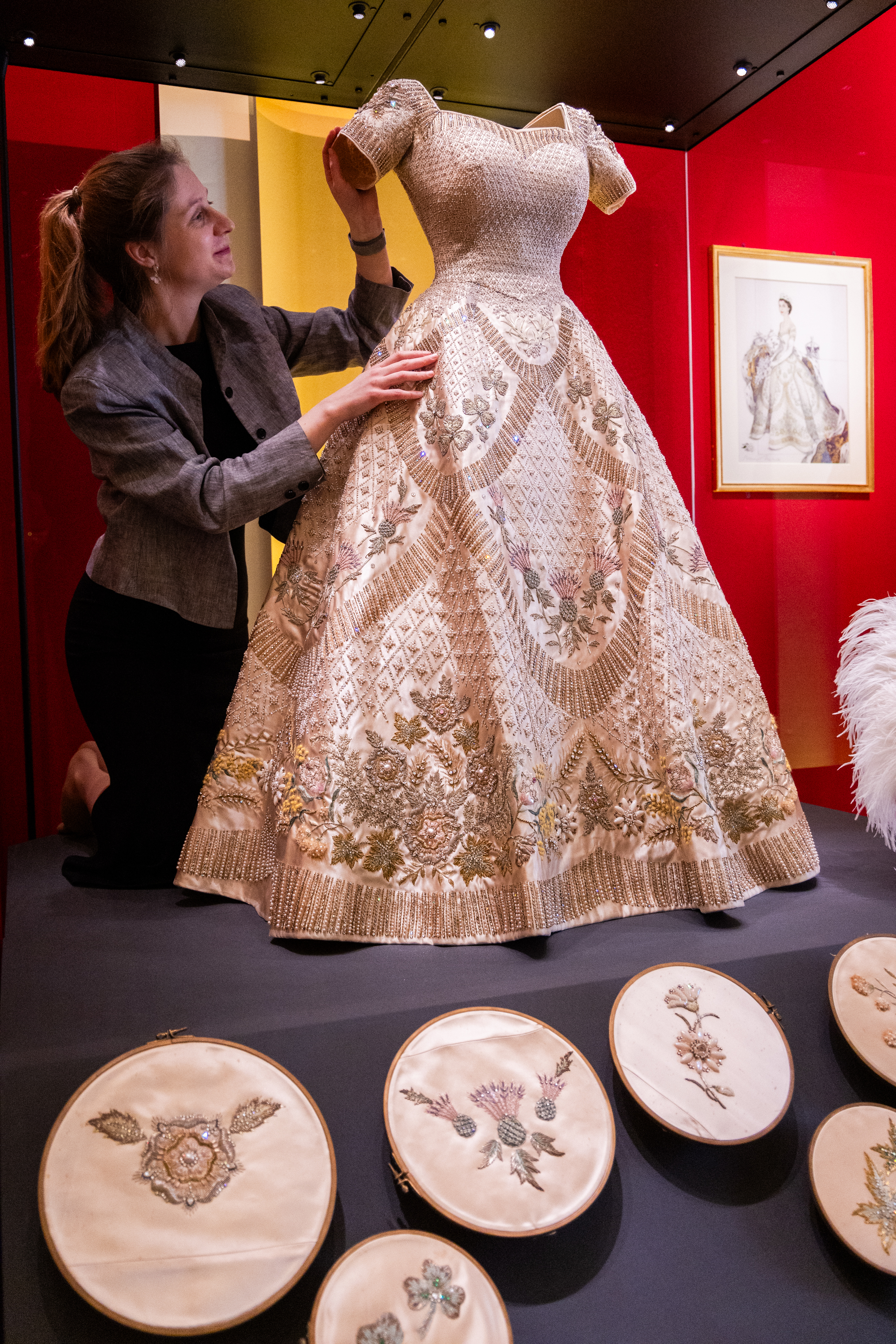 Cecilia Oliver, Textile Conservator, Royal Collection Trust, makes final adjustments to The Coronation Dress