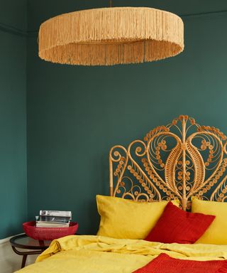 Teal wall bedroom decor with ornate yellow bed frame by COAT Paints