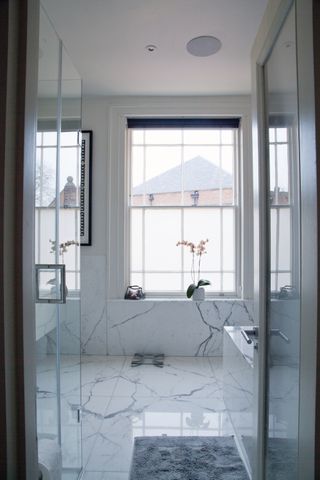 A bathroom with shiny marble tiles