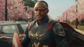 Anthony Mackie stands in uniform with cherry blossoms flanking him in Captain America: Brave New World.