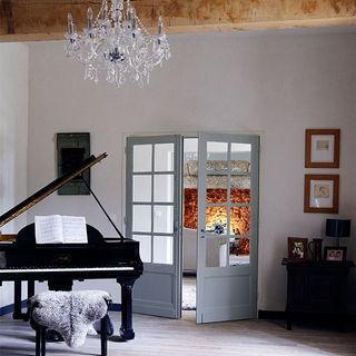 living room with door and piano