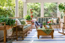 small sunroom with blue and white striped rug