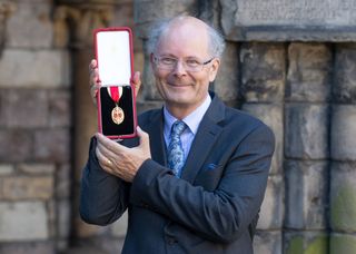 Professor John Curtice after getting his knighthood from the Queen.