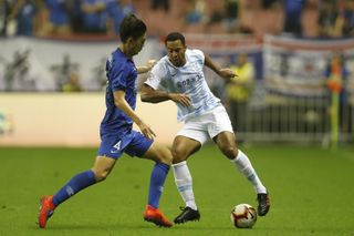 Mousa Dembele (right) on the ball for Guangzhou R&F against Shanghai Shenhua in July 2019.