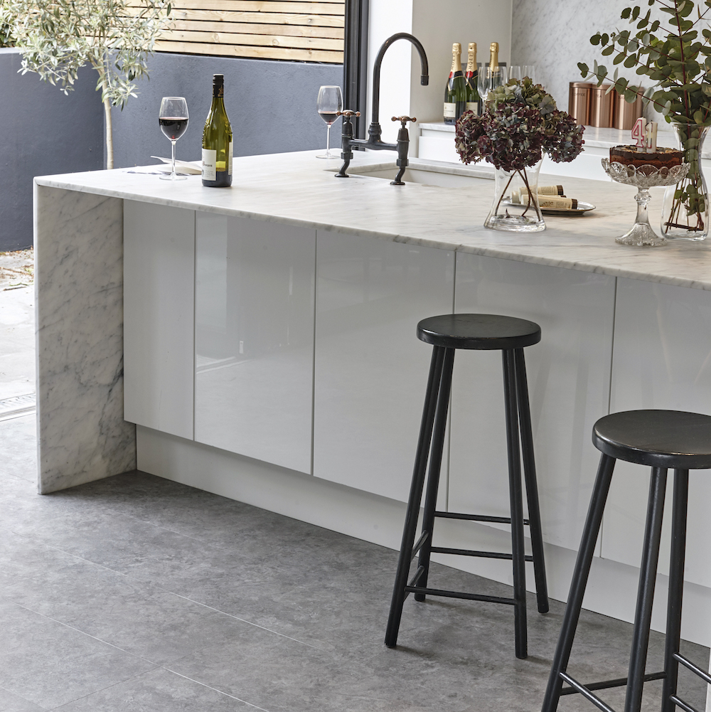 kitchen room with white kitchen worktop and flower in vase