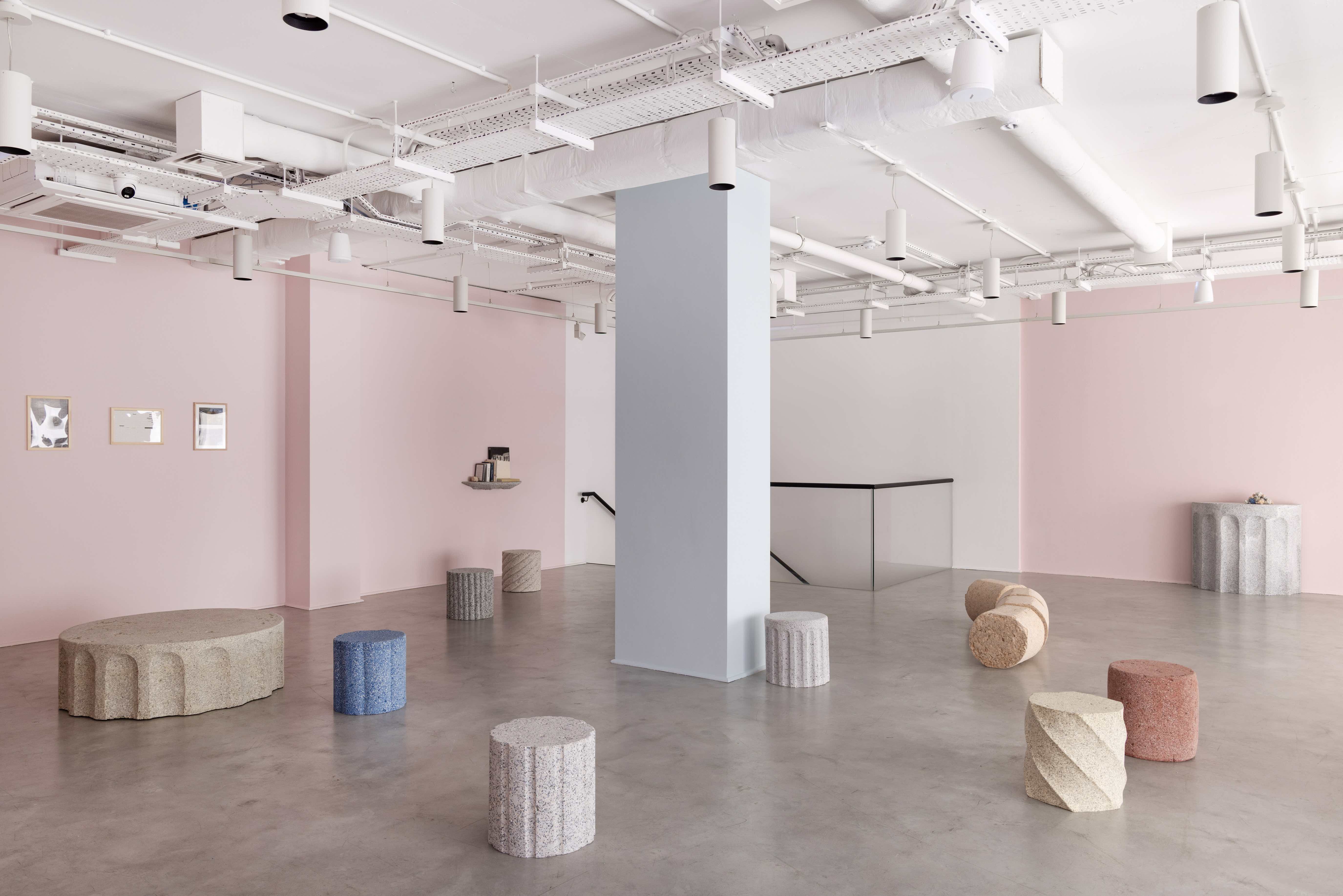 Rubber furniture installed in pink gallery space with concrete floor