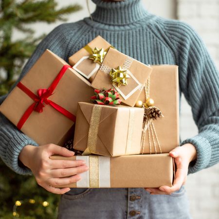 Woman holding pile of gifts