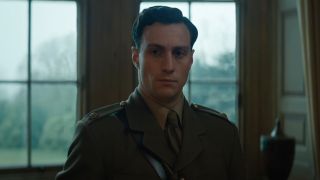 Aaron Taylor-Johnson standing somberly, in a World War I uniform, in The King's Man.