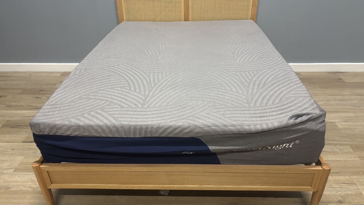 The freshly unboxed SweetNight CoolNest Mattress still expanding on a wooden bed frame.