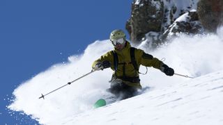 A man telemark skiing in deep powder