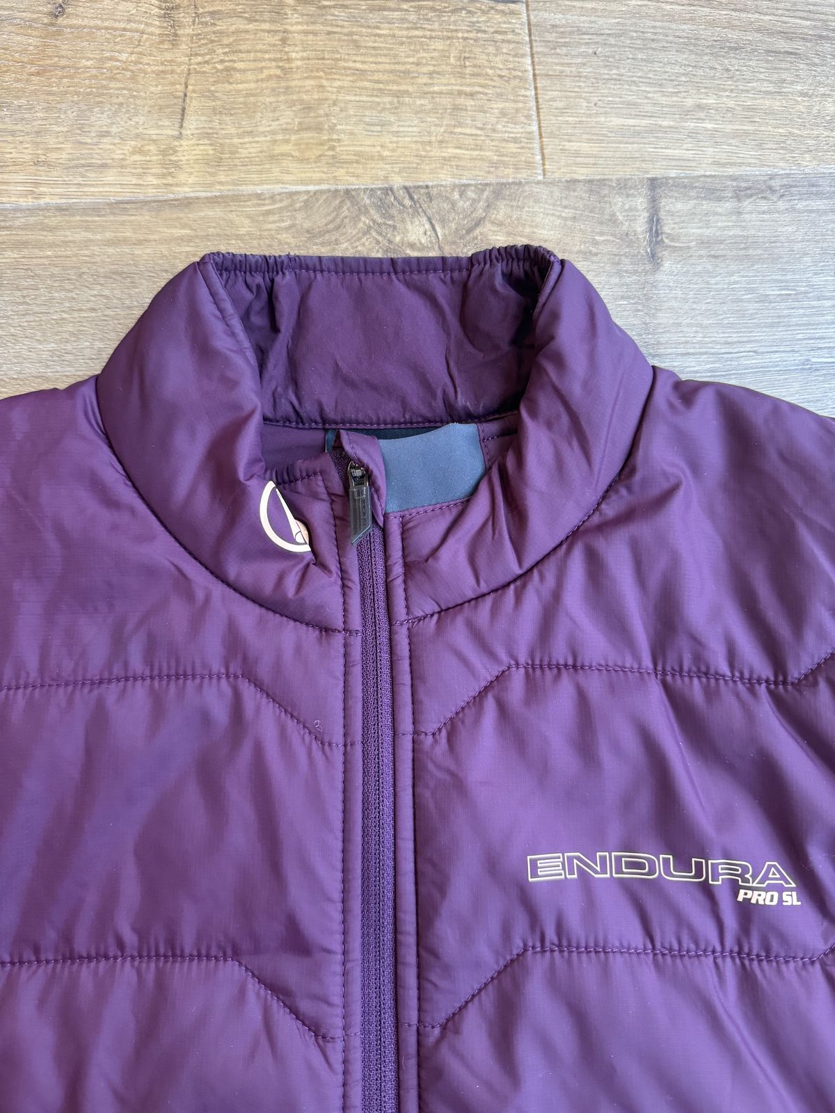 Flay lay endura jacket in burgundy showing the collar detailing