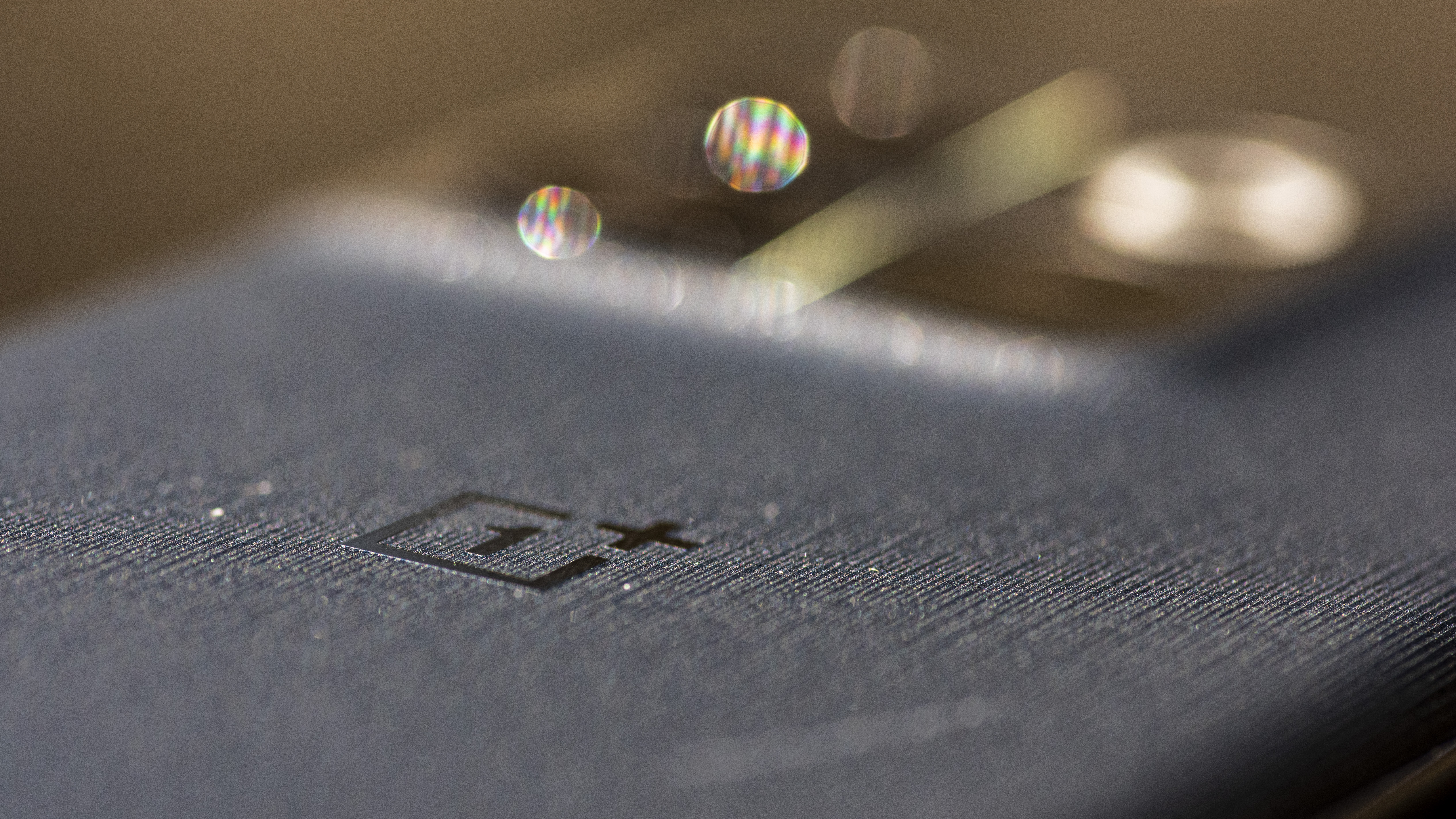 close up texture of OnePlus 10T moonstone black color showing OnePlus logo