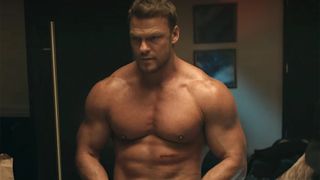 Alan Ritchson showing off his massive muscles as Jack Reacher