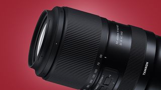 The Tamron 50-400mm F/4.5-6.3 Di III VC VXD lens on a red background