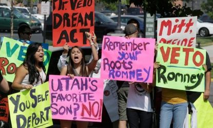 Immigration activists protest outside The Grand America in Salt Lake City, Utah, where Mitt Romney holds a campaign event on Sept. 18.