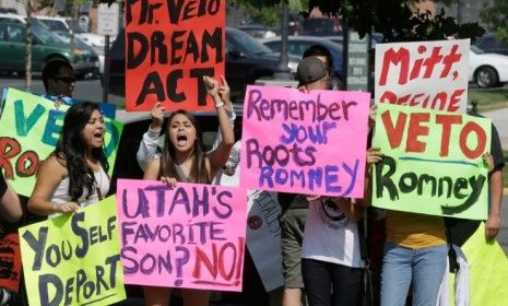 Immigration activists protest outside The Grand America in Salt Lake City, Utah, where Mitt Romney holds a campaign event on Sept. 18.