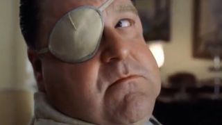 John Goodman looking over his shoulder, wearing an eye patch from O Brother Where Art Thou